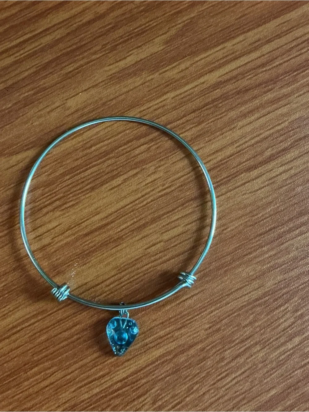 A Brighton silver tone bangle and a no brand bangle with heart shape charm.